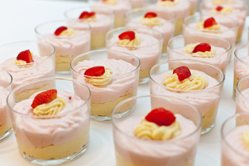 tasty vanilla and strawberry creme  dessert lined up