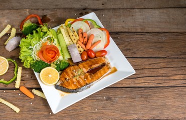 Salmon fillets. Grilled salmon, salmon steak on old wooden table, vintage style 