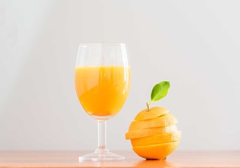 orange juice with orange slice on wood background