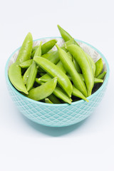 Green sugar snap peas isolated on white background.