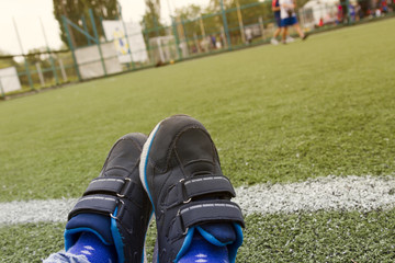 Close up sports sneakers shoes on artificial green grass