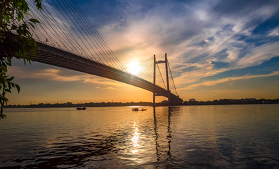 Fototapeta na wymiar Vidyasagar Setu - the cable stayed bridge on river Hooghly at sunset