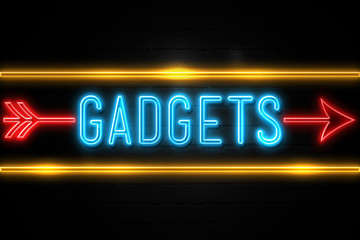 Gadgets  - fluorescent Neon Sign on brickwall Front view
