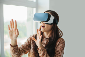 Young woman with virtual reality glasses. Modern technologies. The concept of future technology.