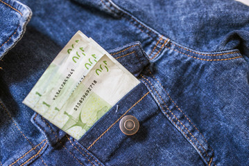Money in the pocket. Close-up of one hundred Euro banknote in jeans pocket.