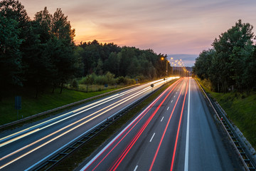 Fototapeta na wymiar Speed traffic on highway at dusk. Colorful light trails on the street. Poland.
