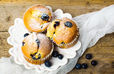 Homemade blueberry muffins on a wooden table