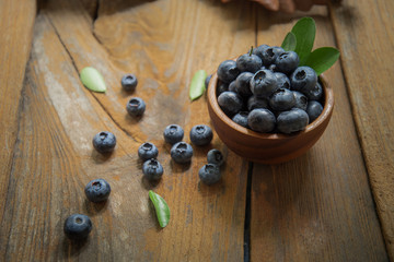 fresh bilberries or blueberries in small wooden bowls