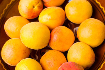 Fresh apricots in a bowl on a rustic table