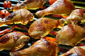 Grilled chicken leg on the flaming grill