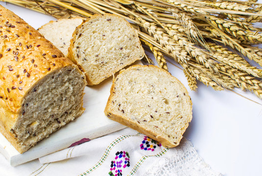 Rye bread slices with seeds and wheat plant