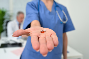 Obraz na płótnie Canvas Nurse giving pills to a patient