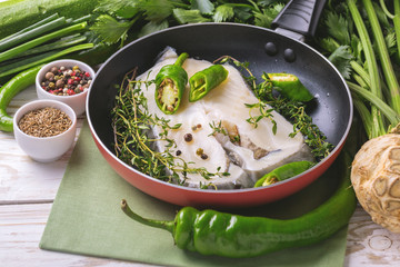 Raw fresh white fish steak with vegetables ingredients