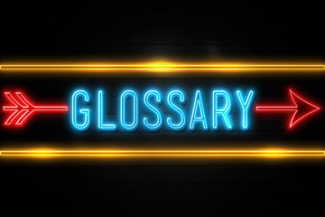 Glossary  - fluorescent Neon Sign on brickwall Front view