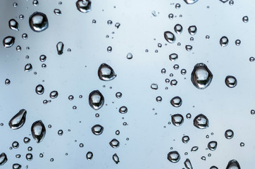 Rain flows on the window pane. Selective focus.