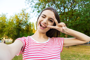 Fototapeta premium Beautiful urban woman taking picture of herself, selfie.
