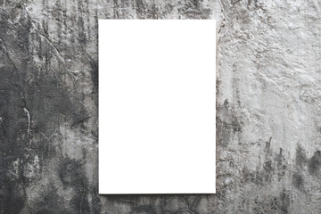 Vertical empty blank canvas or billboard hanging on concrete wall