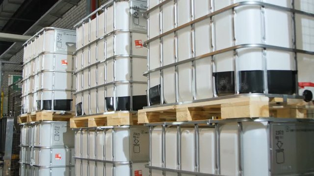 Closeup Forklift Drives Pile Takes and Transports Tanks