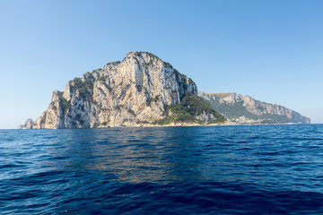 Fototapeta na wymiar The Island of Capri is a very picturesque, luxuriant and extraordinary location in Italy famous for its high rocks.