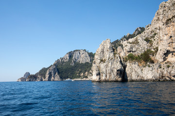 Fototapeta na wymiar View from the boat on the cliff coast of Capri Island