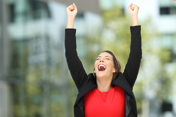 Excited executive raising arms after success