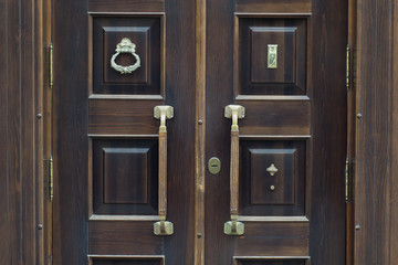 Old brass handle on vintage wood door