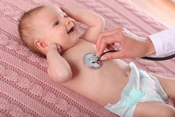 Young doctor examining a baby.