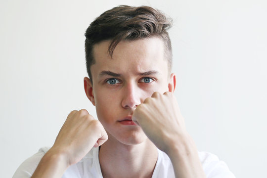 Young tense man with hand in fist