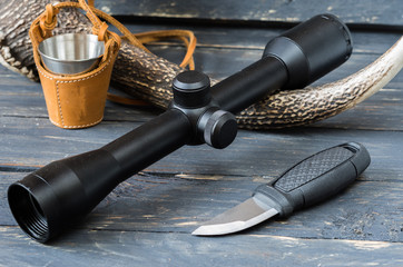 Obraz premium Black optical sight and black knife.