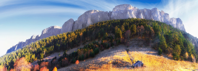 Beautiful scenic golden autumn landscape of majestic Bolshoy Tkhach rocky mountain peak under blue...