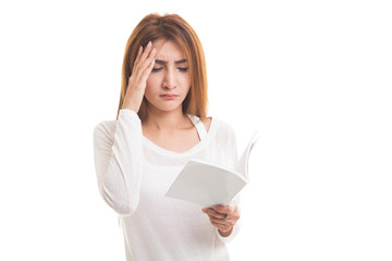 Young Asian woman got headache read a book.