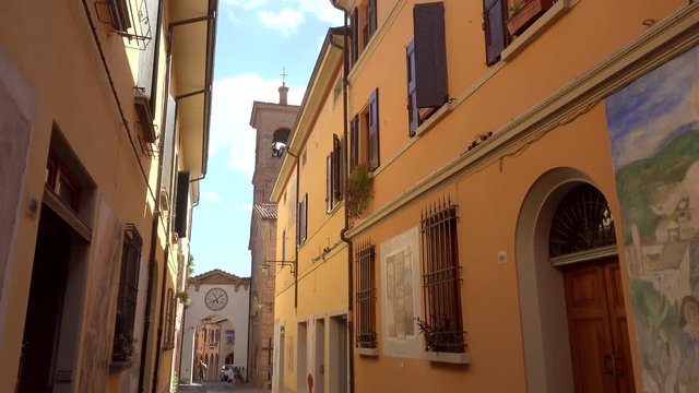 cinematic shot of colorful street of the medieval village of Dozza, a small gem among the architectural wonders of Italy