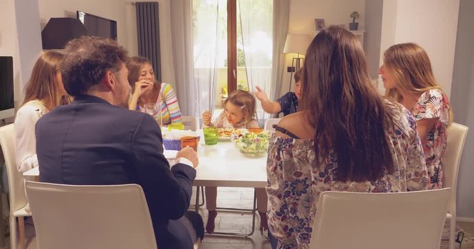 Happy family talking during lunch laughing and smiling