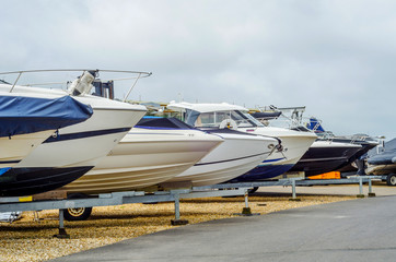 Boat on stand on the shore, close up on the part of the yacht, luxury ship, maintenance and parking place boat