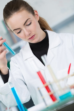 woman with pipette and test-tubes