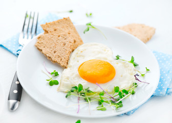 Healthy breakfast. Fried heart shaped egg closeup