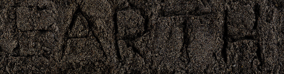 Dark Soil. Pile of Dirt and Stones. Top View of a Heap of Ground. Close Up Macro View with Text earth