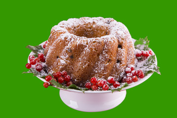 Christmas pudding with a viburnum on a green background
