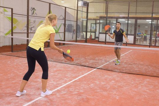 couple playing tennis game indoor tennis court