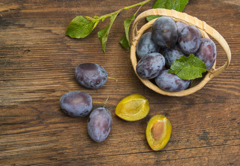 garden plums on a wooden table close up
