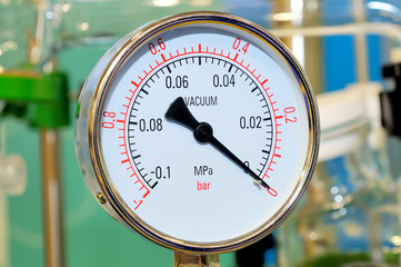 Industrial pressure gauge on blurry background
