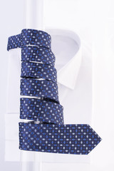 Blue tie with a twisted spiral on a transparent pole and a white shirt on a white background