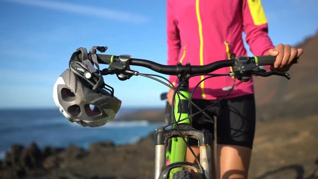 Mountain bike, Woman cyclist and MTB bike helmet closeup. Female athlete mountain biking.