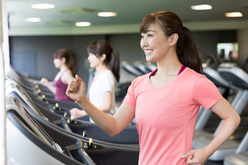 sporty asian women exercising in sports gym