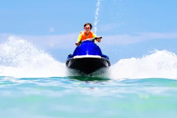 Garden poster Water Motor sports Teenager on water scooter. Teen age boy water skiing.