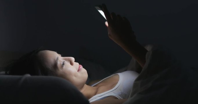 Woman using mobile phone to send text message