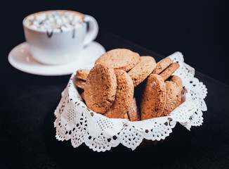 French cookies with jam on the white plate.