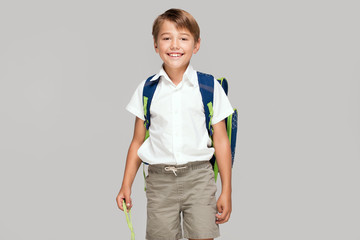 Smiling little boy with backpack.