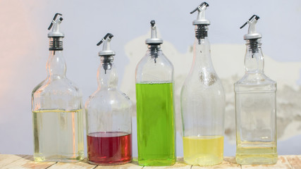 Four bottles of syrup on a wooden table