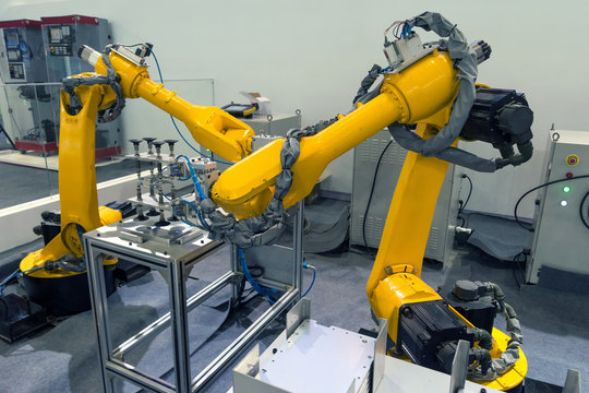 Manufacturing production industrial machine , factory robots arm in smart factory and industry 4.0 concept.